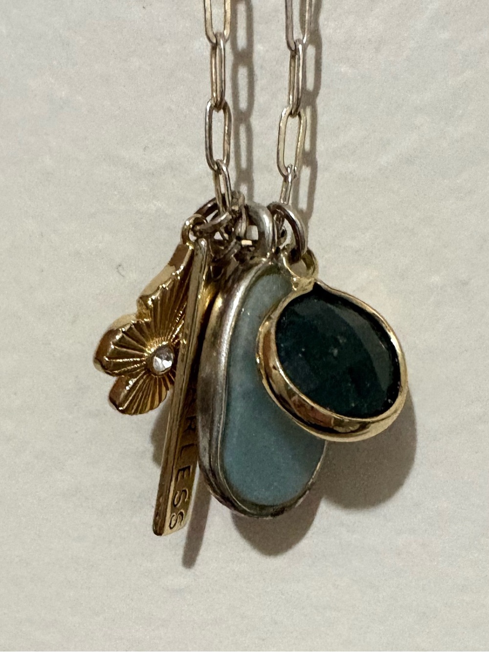 This Believe by Brilliance charm necklace features a “Fearless” bar pendant
